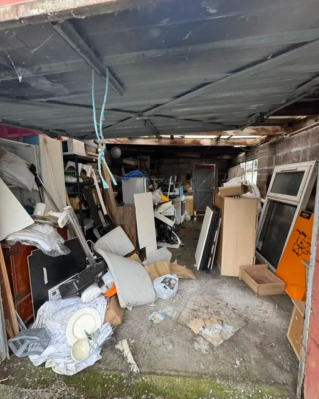 Before: Garage clearance. Packed garage emptied and swept