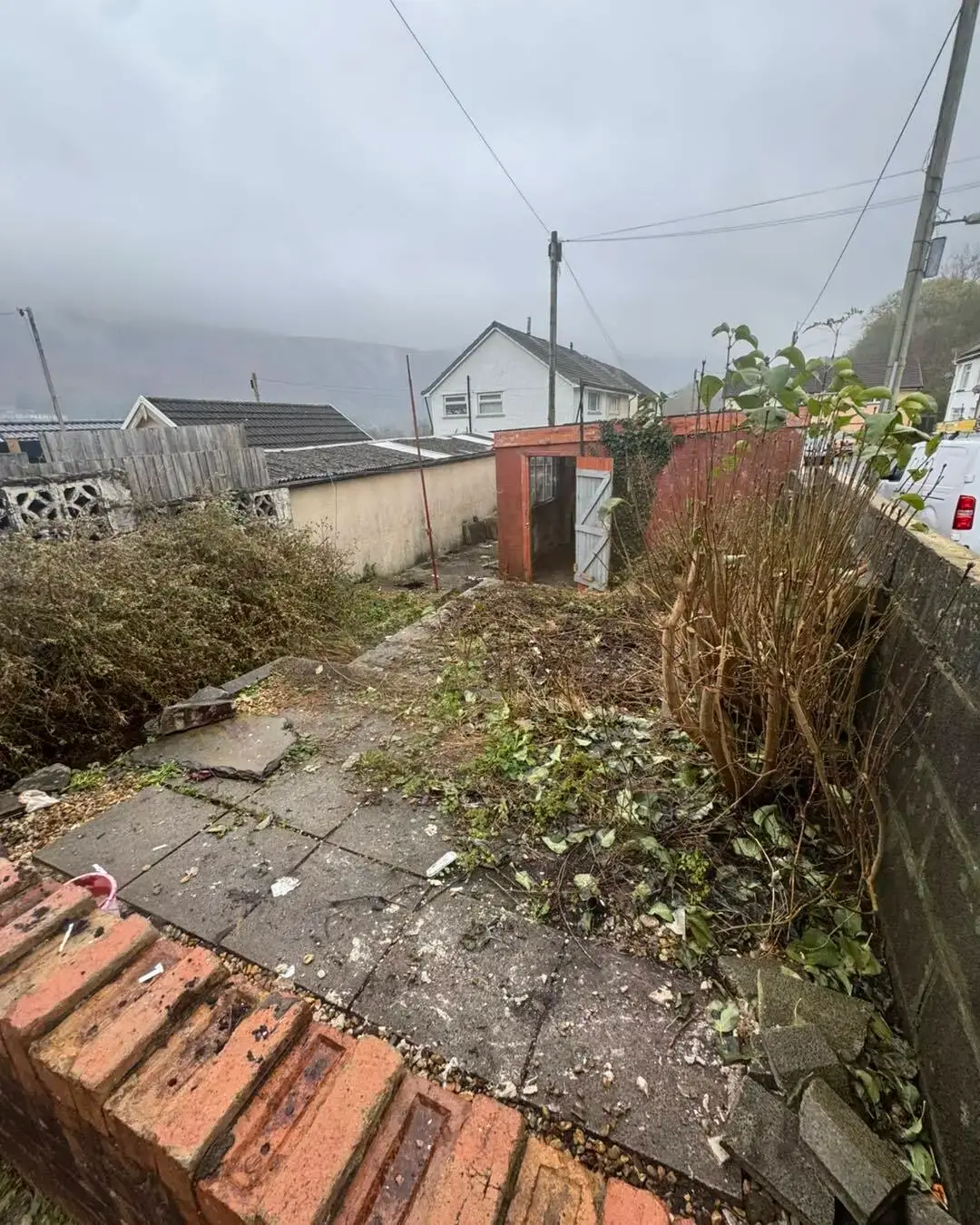 After: Garden clearance. Broken furniture and rubbish cleared from a valley garden