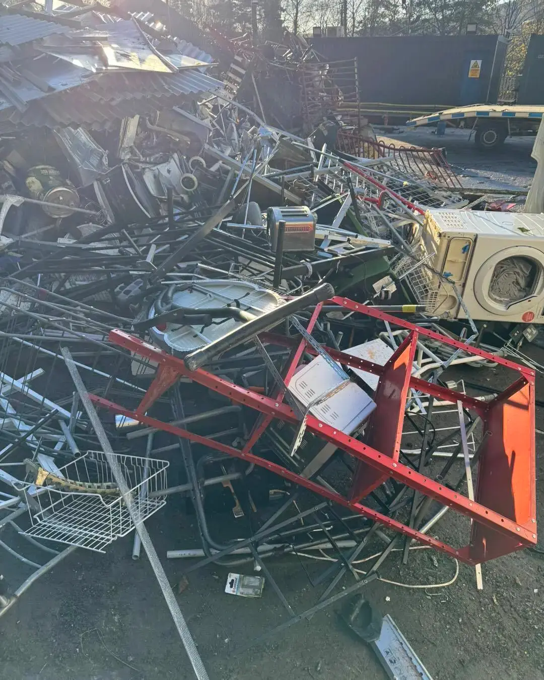 Scrap metal, a washing machine and shelving at a metal recycling yard